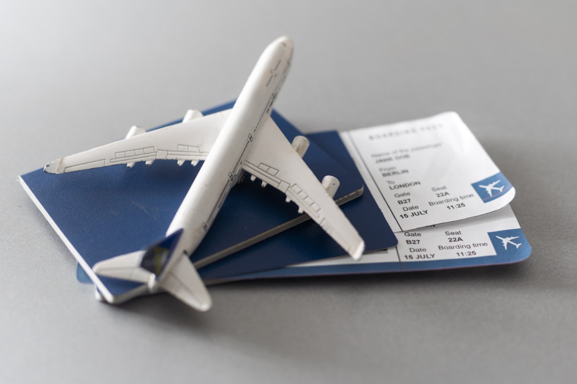 airline tickets and documents on wooden table top utc